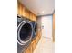 Spacious laundry room includes a modern washer and dryer and ample cabinet space at 6101 Browning Way, Las Vegas, NV 89130