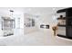 Bright living room featuring marble floors, a fireplace, and a stylish display cabinet at 6101 Browning Way, Las Vegas, NV 89130
