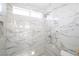 Stylish shower with marbled tile, rainfall shower head, and modern fixtures at 6101 Browning Way, Las Vegas, NV 89130