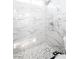 Shower with marbled tile, rainfall shower head, and modern tile mosaic floor at 6101 Browning Way, Las Vegas, NV 89130