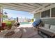Inviting backyard pool area with seating, covered patio, and desert landscaping at 6432 Aberdeen Ln, Las Vegas, NV 89107