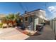 Side exterior featuring mature palms, providing a private and lush outdoor living area with potential for relaxation at 6432 Aberdeen Ln, Las Vegas, NV 89107