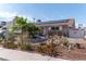 Charming single-story home with solar panels and unique desert landscaping in the front yard at 6432 Aberdeen Ln, Las Vegas, NV 89107