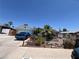 Charming single-story home featuring a desert landscape and a blue car in the driveway at 6432 Aberdeen Ln, Las Vegas, NV 89107