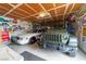 Spacious garage filled with vehicles and decorated with memorabilia, perfect for car enthusiasts and hobbyists at 6432 Aberdeen Ln, Las Vegas, NV 89107