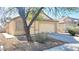Single story home with a tan exterior, low maintenance desert landscaping, and two car garage at 6516 Velvet Silk St, North Las Vegas, NV 89084