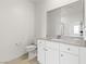 A modern bathroom with a white vanity, gray countertop, and a stylish mirror at 6737 Lotus Vista Ct, Las Vegas, NV 89156