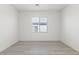 Bright, airy bedroom with neutral walls, a large window, and light wood-look flooring at 6737 Lotus Vista Ct, Las Vegas, NV 89156