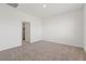 A clean and bright bedroom with neutral carpet, white walls, and a walk-in closet at 6737 Lotus Vista Ct, Las Vegas, NV 89156