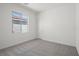 Bright bedroom with a window providing natural light, neutral carpet and white walls at 6743 Violet Cascade Ave, Las Vegas, NV 89156