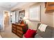 Bedroom with a wooden dresser, striped chair, and a view of the hallway at 6955 N Durango Dr # 3013, Las Vegas, NV 89149