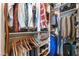 Organized walk-in closet with hanging clothes and shelf storage at 6955 N Durango Dr # 3013, Las Vegas, NV 89149