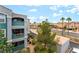Exterior view of an apartment building with green spaces and palm trees along the street at 6955 N Durango Dr # 3013, Las Vegas, NV 89149