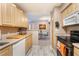 Open kitchen featuring a view of the dining area, bright cabinetry, and stainless appliances at 6955 N Durango Dr # 3013, Las Vegas, NV 89149