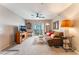 Comfortable living room with ceiling fan, slider to outdoor patio, and neutral carpet at 6955 N Durango Dr # 3013, Las Vegas, NV 89149