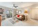 Cozy living room featuring plush seating, ceiling fan, and sliding glass doors to a patio at 6955 N Durango Dr # 3013, Las Vegas, NV 89149