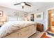 Bright primary bedroom with a large bed, ceiling fan, and adjacent bathroom access at 6955 N Durango Dr # 3013, Las Vegas, NV 89149
