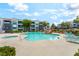Community pool area with lounge chairs, lush landscaping, and comfortable seating at 6955 N Durango Dr # 3013, Las Vegas, NV 89149