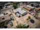 Aerial of a home featuring a detached garage, landscaping, and multiple parked vehicles at 704 Kings Ave, North Las Vegas, NV 89030