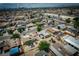 An aerial shot captures neighborhood homes, trees, and city view at 704 Kings Ave, North Las Vegas, NV 89030