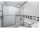 Clean bathroom featuring a tub/shower combination with swan design sliding doors at 704 Kings Ave, North Las Vegas, NV 89030