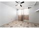 Bright bedroom with ceiling fan and large window with patterned curtains at 704 Kings Ave, North Las Vegas, NV 89030