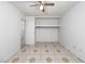 Bedroom featuring a ceiling fan, built in shelving, and patterned tile at 704 Kings Ave, North Las Vegas, NV 89030