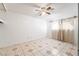 Bedroom featuring a ceiling fan and large window with patterned curtains at 704 Kings Ave, North Las Vegas, NV 89030