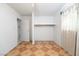 This bedroom features tile flooring, white walls, and a built-in shelving unit for storage at 704 Kings Ave, North Las Vegas, NV 89030
