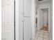 Bright hallway featuring neutral walls, tile flooring and white trim throughout at 704 Kings Ave, North Las Vegas, NV 89030