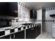 Unique kitchen design featuring checkerboard countertops, black cabinets, and a window at 704 Kings Ave, North Las Vegas, NV 89030