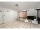 Bright living room featuring tiled floors, neutral walls, and minimalist decor at 704 Kings Ave, North Las Vegas, NV 89030