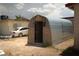 This shed is made with metal and wood and has a door in the center at 704 Kings Ave, North Las Vegas, NV 89030