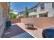 Private backyard area with a brick wall, patio furniture, and gravel landscaping at 9112 Canoga Canyon Ct # 103, Las Vegas, NV 89149