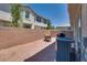 Private backyard area with a brick wall, patio furniture, and gravel landscaping at 9112 Canoga Canyon Ct # 103, Las Vegas, NV 89149