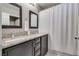 Bathroom featuring a double sink vanity and a shower with a curtain at 9112 Canoga Canyon Ct # 103, Las Vegas, NV 89149
