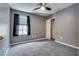 Neutral toned bedroom with a large window, carpet flooring, and closet space at 9112 Canoga Canyon Ct # 103, Las Vegas, NV 89149