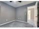 Carpeted bedroom featuring a ceiling fan and a doorway at 9112 Canoga Canyon Ct # 103, Las Vegas, NV 89149
