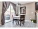 Dining area with modern light fixture, seating for four, with sliding glass doors leading to outdoor space at 9112 Canoga Canyon Ct # 103, Las Vegas, NV 89149