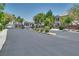 Gated community entrance with well-maintained landscaping and mature trees at 9112 Canoga Canyon Ct # 103, Las Vegas, NV 89149