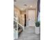 Bright entryway featuring tile floors, staircase, and neutral wall colors at 9112 Canoga Canyon Ct # 103, Las Vegas, NV 89149