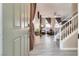 Inviting home entryway leading to the living room with tile flooring and a staircase at 9112 Canoga Canyon Ct # 103, Las Vegas, NV 89149