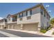 View of townhome exterior featuring multiple attached garages, shutters, and well maintained community at 9112 Canoga Canyon Ct # 103, Las Vegas, NV 89149
