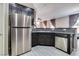 Kitchen showcasing stainless steel appliances, granite countertops, and ample counter space with view into living area at 9112 Canoga Canyon Ct # 103, Las Vegas, NV 89149