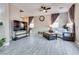 Bright and airy living room featuring modern decor, tile flooring, and ample natural light through large windows at 9112 Canoga Canyon Ct # 103, Las Vegas, NV 89149