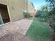 This backyard features a small patio, rock landscaping and a patch of artificial turf at 10537 Thor Mountain Ln, Las Vegas, NV 89166
