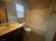 Well-lit bathroom features a sink, toilet, and bathtub with shower, offering essential amenities at 10537 Thor Mountain Ln, Las Vegas, NV 89166