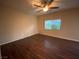 This is a photo of a nice, neutral-colored bedroom with wood floors, a window, a ceiling fan, and natural light at 10537 Thor Mountain Ln, Las Vegas, NV 89166