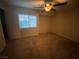 Inviting bedroom complete with a ceiling fan and a window providing natural light at 10537 Thor Mountain Ln, Las Vegas, NV 89166