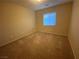 Cozy bedroom featuring neutral carpet and a window with blinds for natural light at 10537 Thor Mountain Ln, Las Vegas, NV 89166